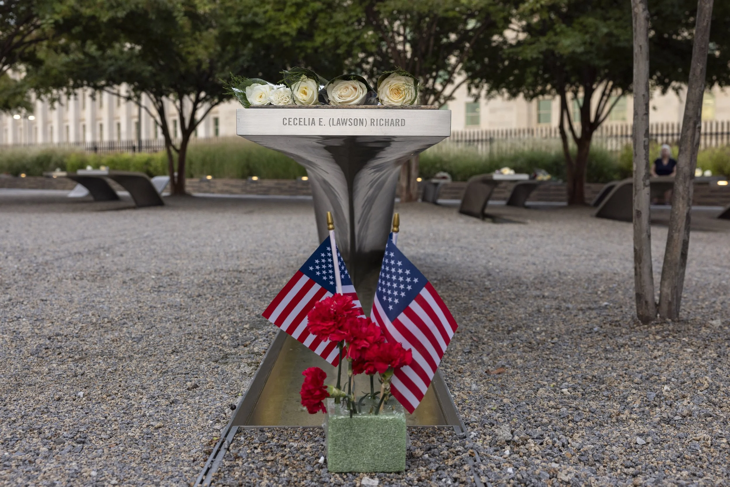 ARLINGTON, Va. — Flowers are left at the Pentagon Memorial in remembrance of the victims on Sept. 11, 2026, the 25th anniversary of the 9/11 attacks. (Liz Helgesen/Photo)