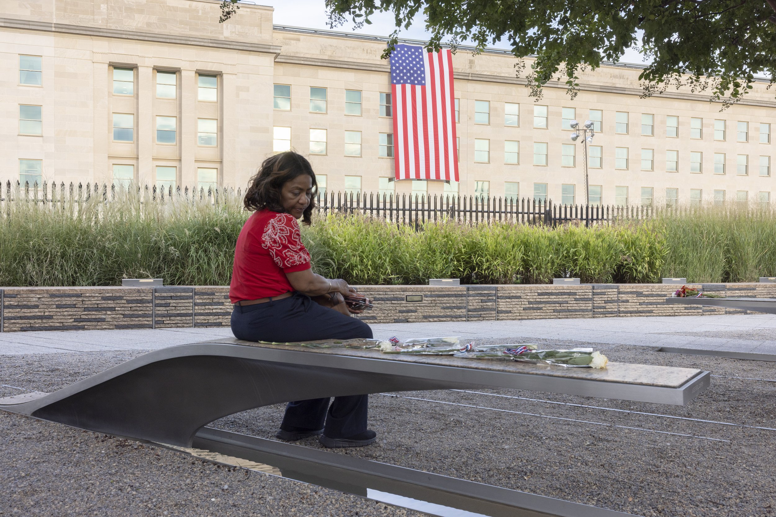 ARLINGTON, Va. — Vallerie Pringel visits the Pentagon Memorial in memory of her cousin on Sept. 11, 2026, the 25th anniversary of the 9/11 attacks. (Liz Helgesen)