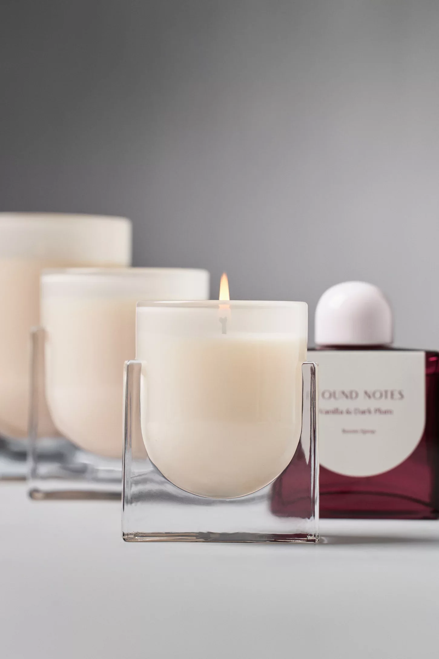 Candle from Anthropologie in clear glass vessel with modern square shape. Vanilla and plum scent, Found Notes Candle