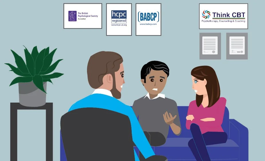 A therapist conducting a counseling session with two clients in an office. The therapist is facing away from the camera, while the two clients, a man and a woman, are seated on a blue sofa, engaging in conversation.