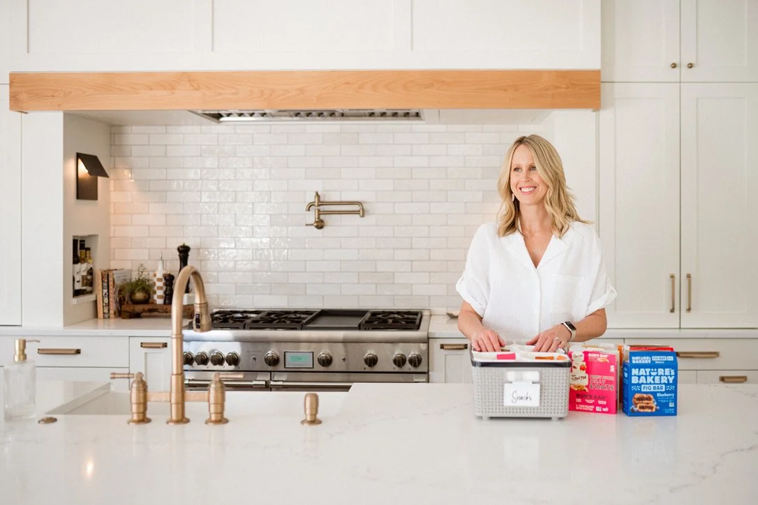 Home organizer Sarah Larsen organizing snacks in a kitchen