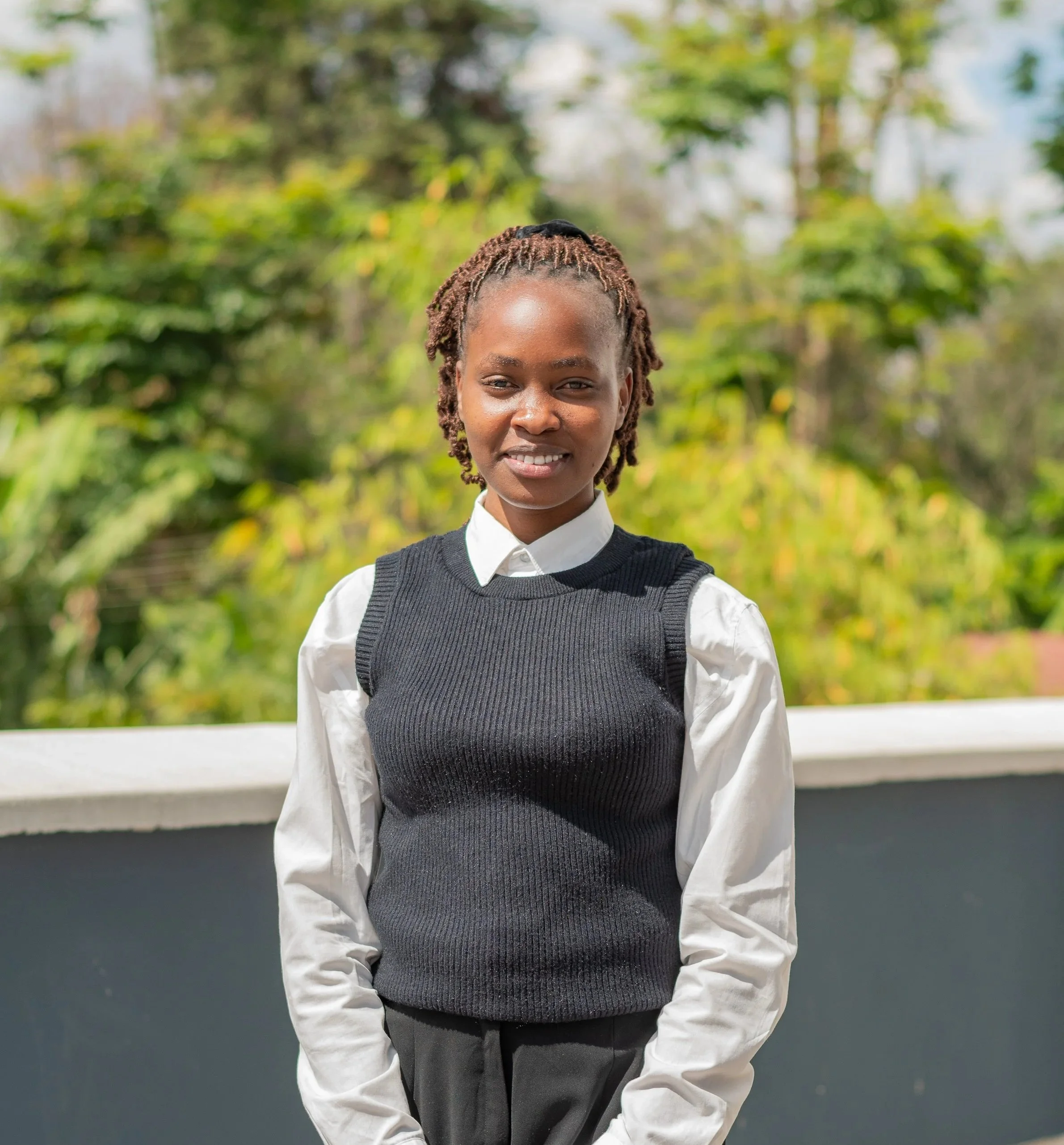 Vanessa Rose Paul KamiLimu Mentee Wearing White Shirt and Grey Sweater