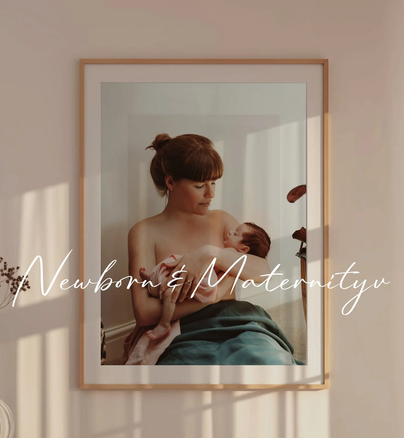 Mother holding newborn baby girl. She is in a picture frame and the tones are warm.