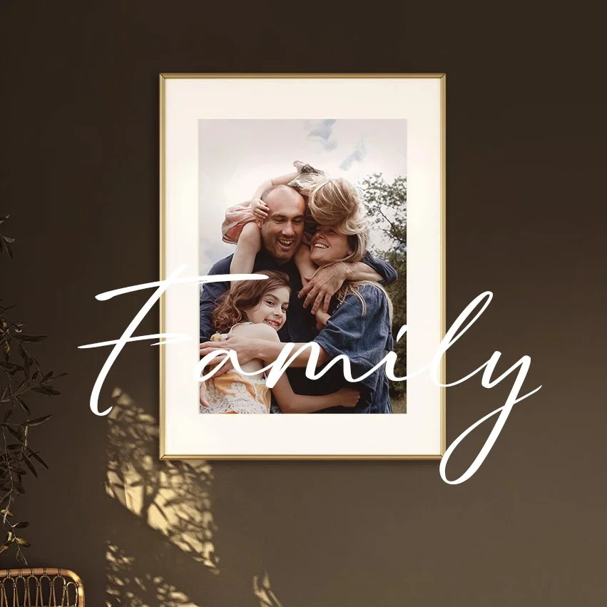 Photograph of a family hugging on a hill in the evening sun.