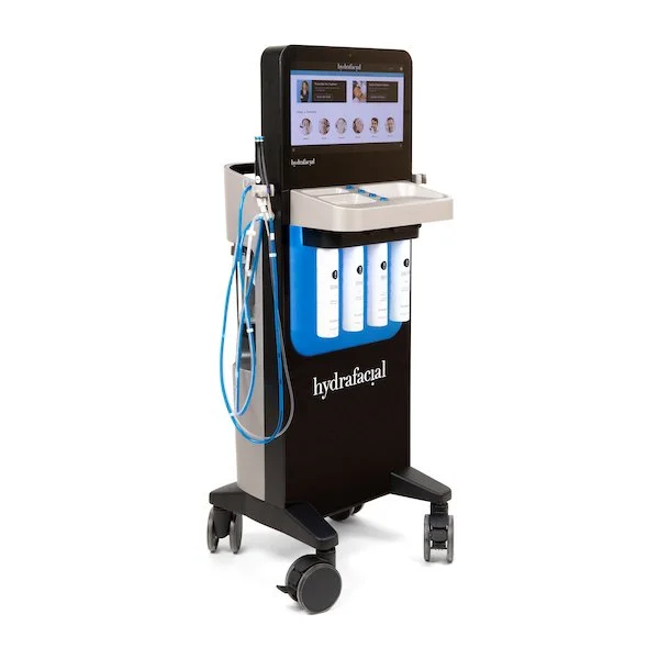 Medspa Hydrafacial machine with touchscreen display, facial treatment attachments, and bottles of skincare solutions.
