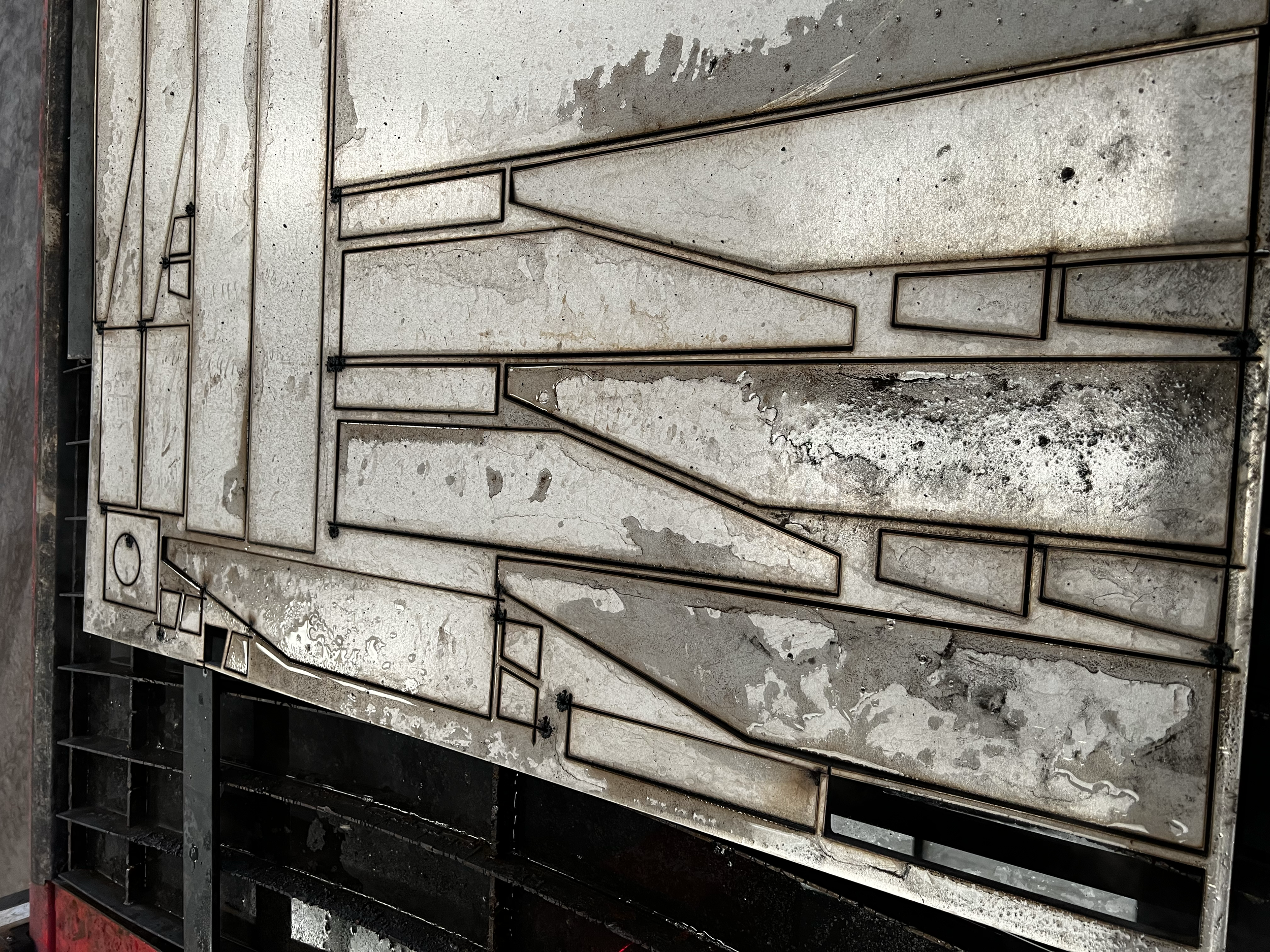 Close-up view of a construction site showing steel framework and concrete slabs that are being assembled for a building.