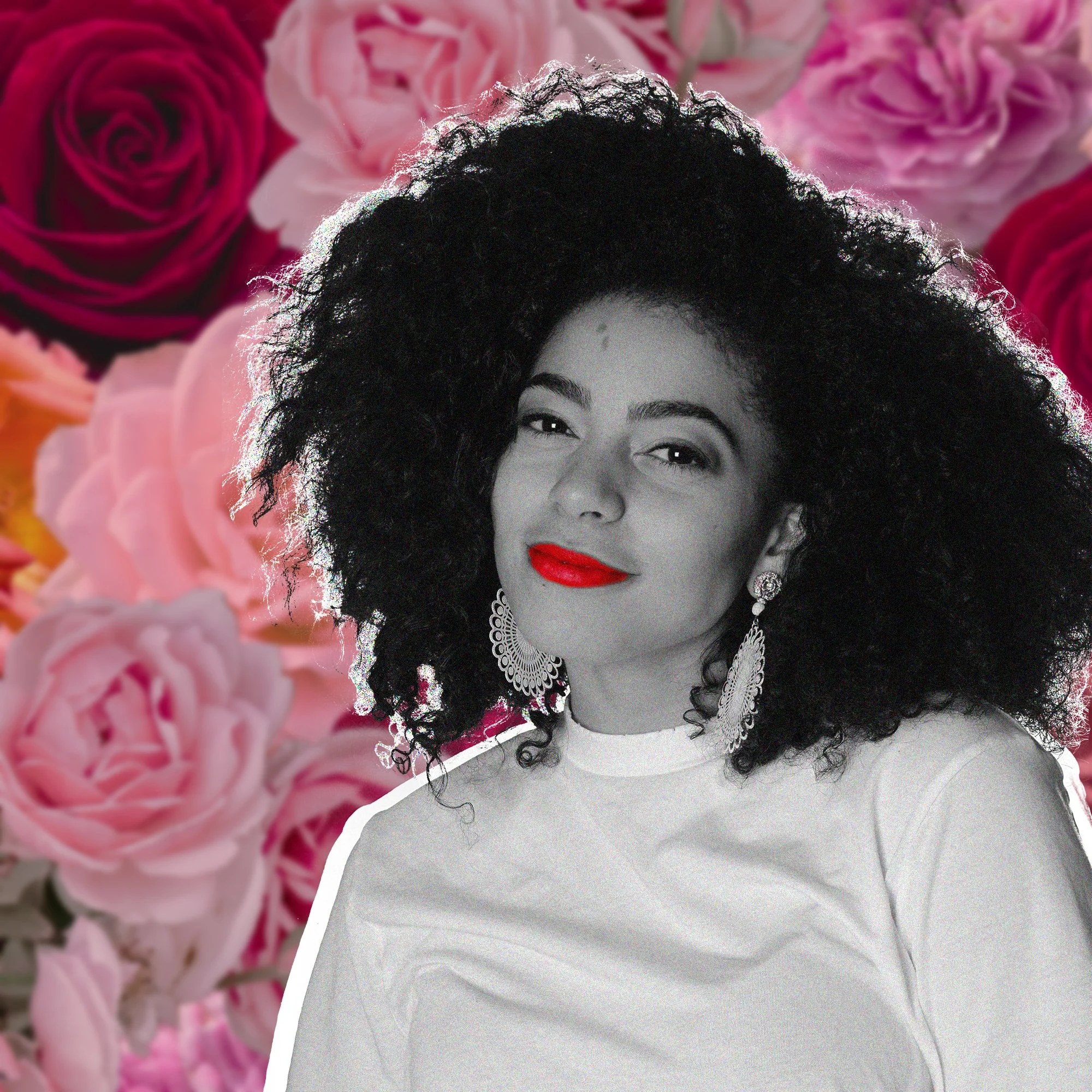 An image of Avril, a beautiful woman with curly hair and floral background that is smiling and looking into the camera.