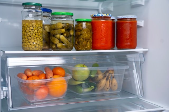 foods stored in plastic container and glass jars in the refrigerator