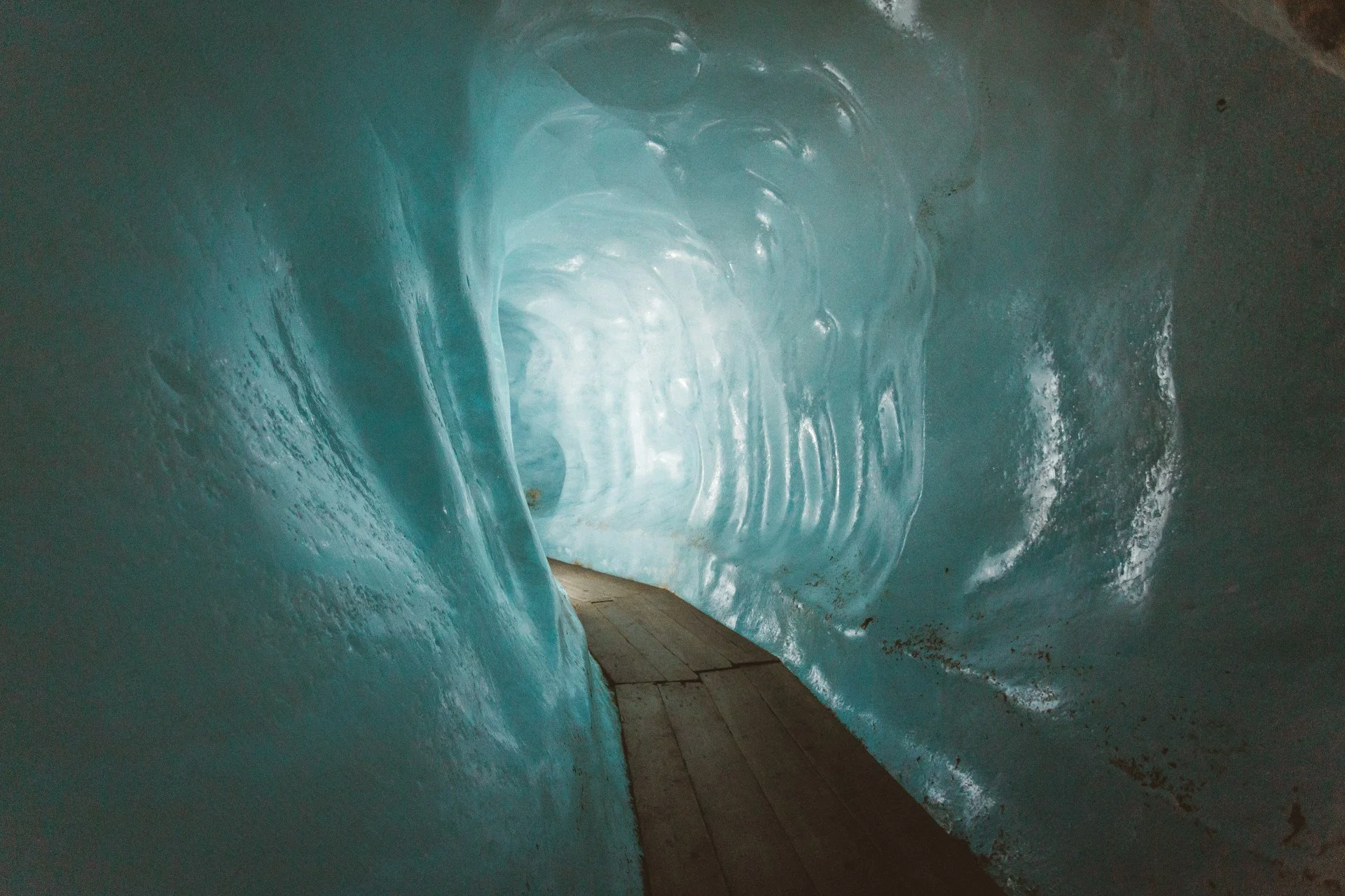 A close-up of still, blue ice cave reflecting light across a wooden floor, evoking calm and depth of the TCM Winter journey.