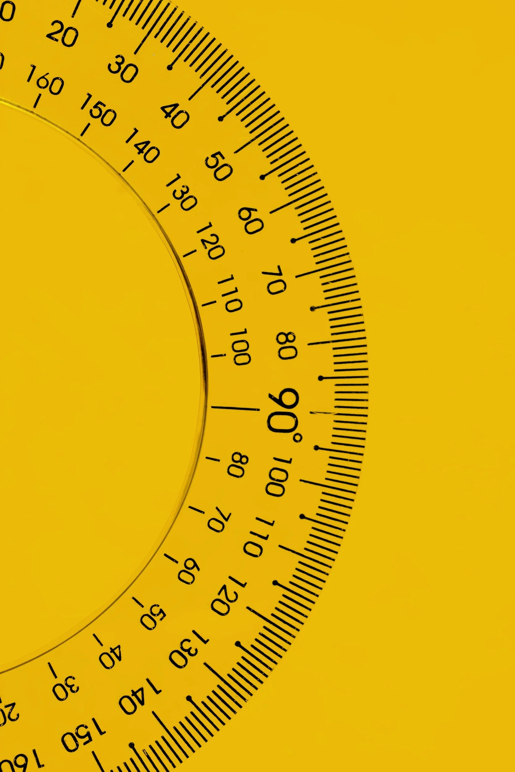 Close-up of a yellow protractor used to measure angles