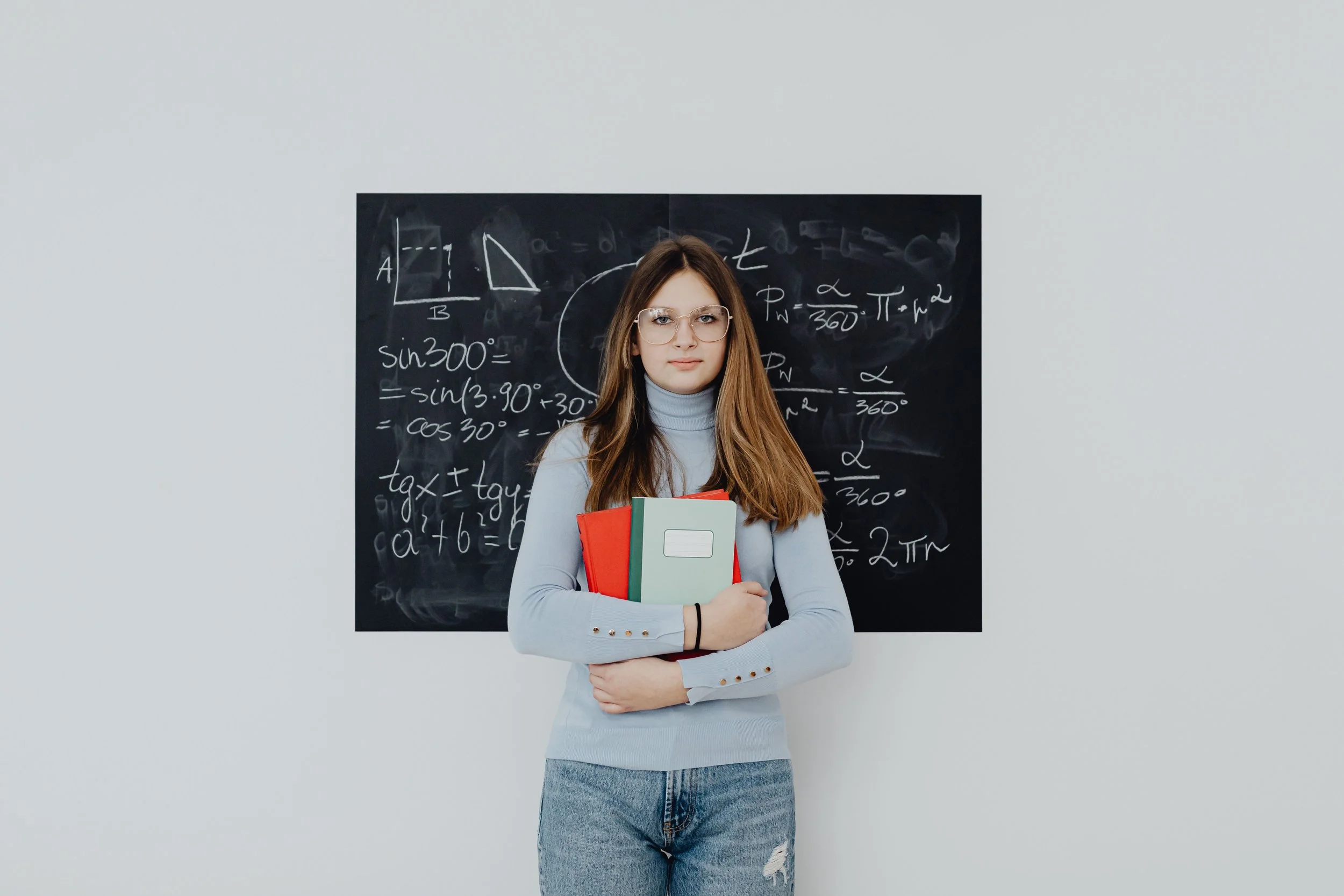 Girl standing holding books