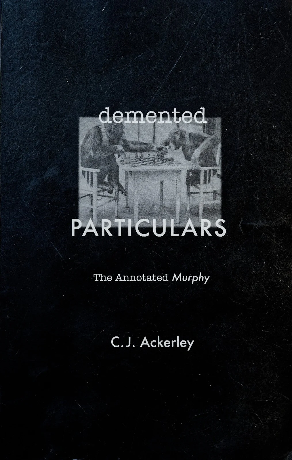 Book cover titled "Demented Particulars: The Annotated Murphy" by C.J. Ackerley, featuring a black-and-white photo of two chimpanzees playing chess.