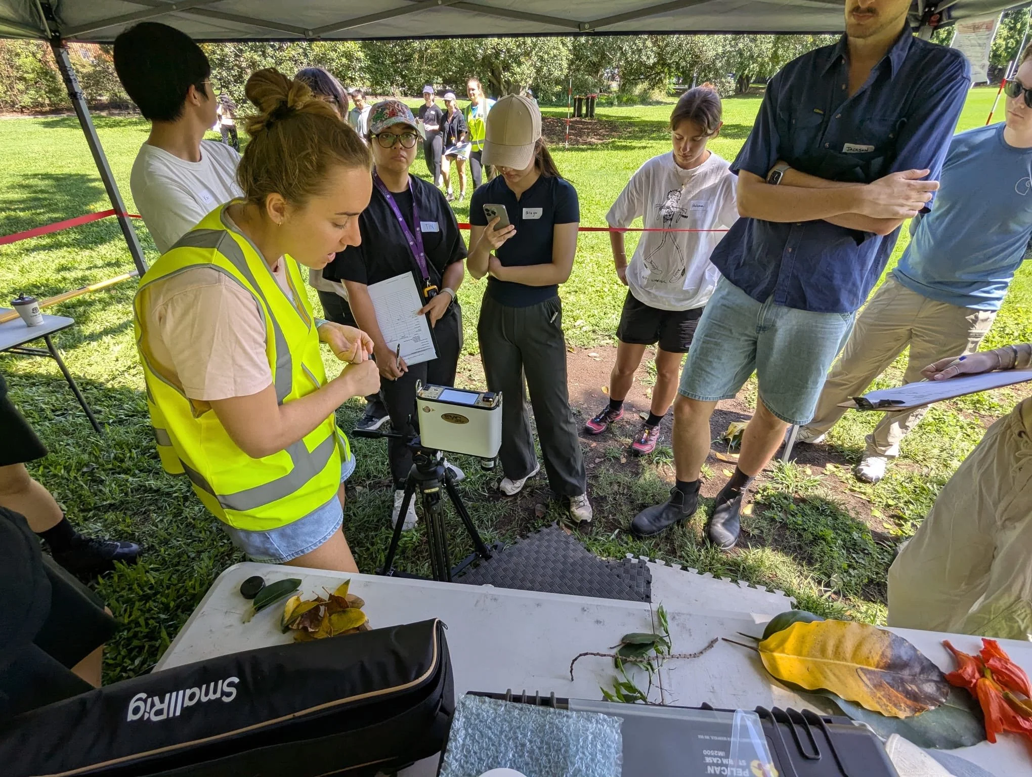 PhD student Joanna Smart (yellow vest)  demonstrating collection of spectral reflectance measurements