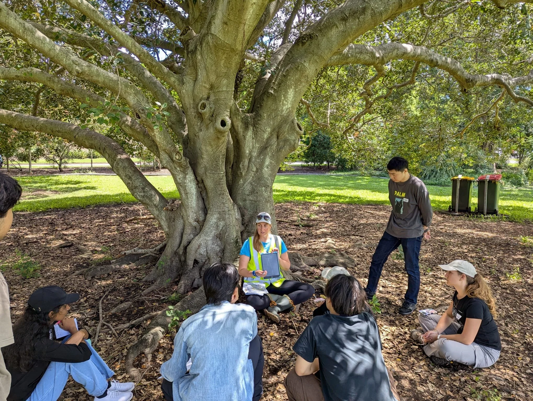 PhD student Gillian Rowan (yellow vest) demonstrating collection of field data
