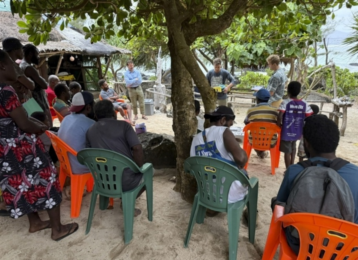 UQ staff conducting community information session on Pele Island. Photo: Gillian Rowan.