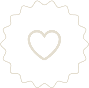 A black circular badge with a white heart in the center and a wavy border.
