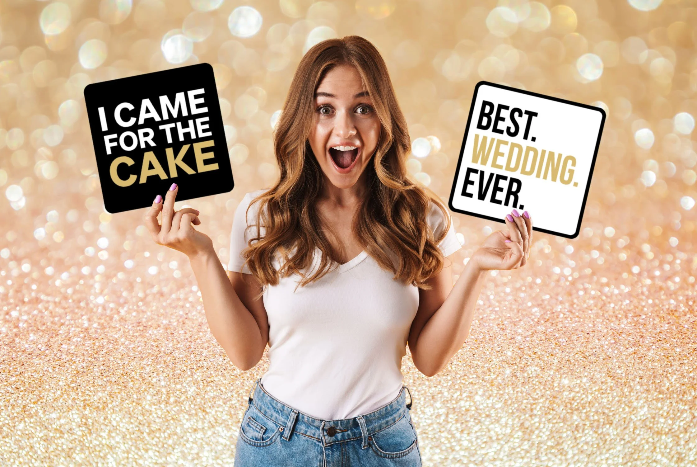 A woman with long, wavy brown hair is smiling and holding two signs. The sign in her left hand says, "I CAME FOR THE CAKE" on a black background, and the sign in her right hand says, "BEST. WEDDING. EVER." on a white background with black and gold text. The background is glittery gold.