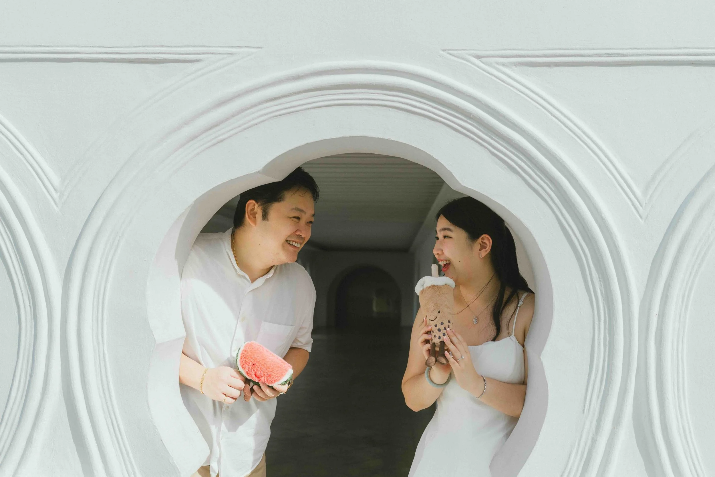 Couple mid-laugh, late light, unposed and unaware