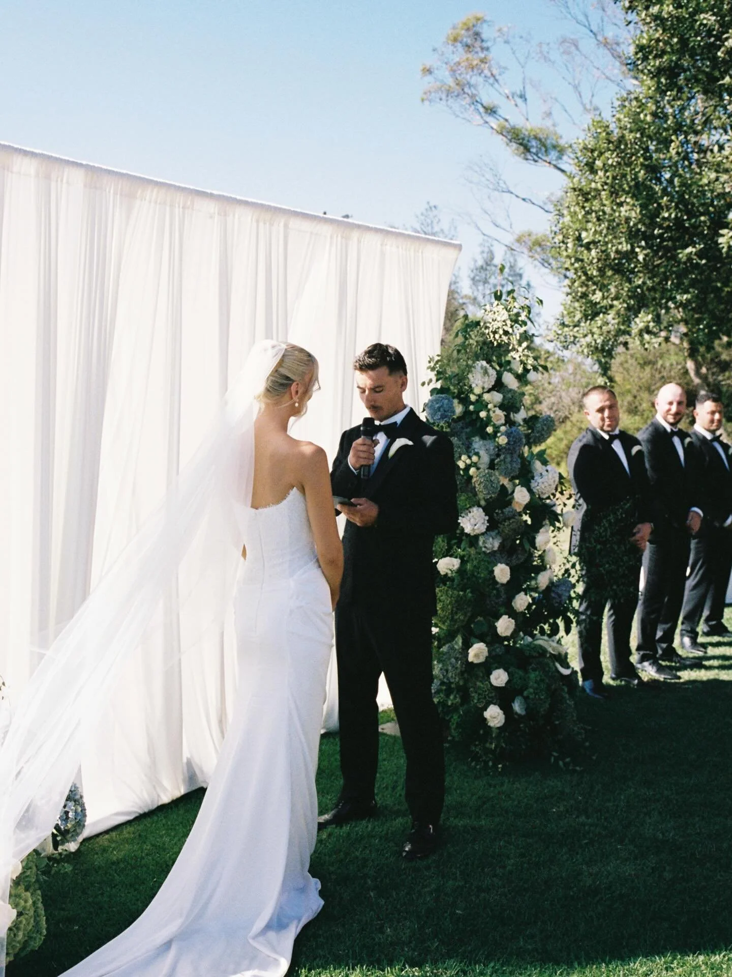Our draping backdrop making the perfect setting for Gemma &amp; Hayden&rsquo;s wedding last month at @terindahestate 🕊️🌳💍

Film &amp; Photography by @mandywood.studio 
Florals by @theposieplaceweddingsandevents 
Chairs @friday.hire