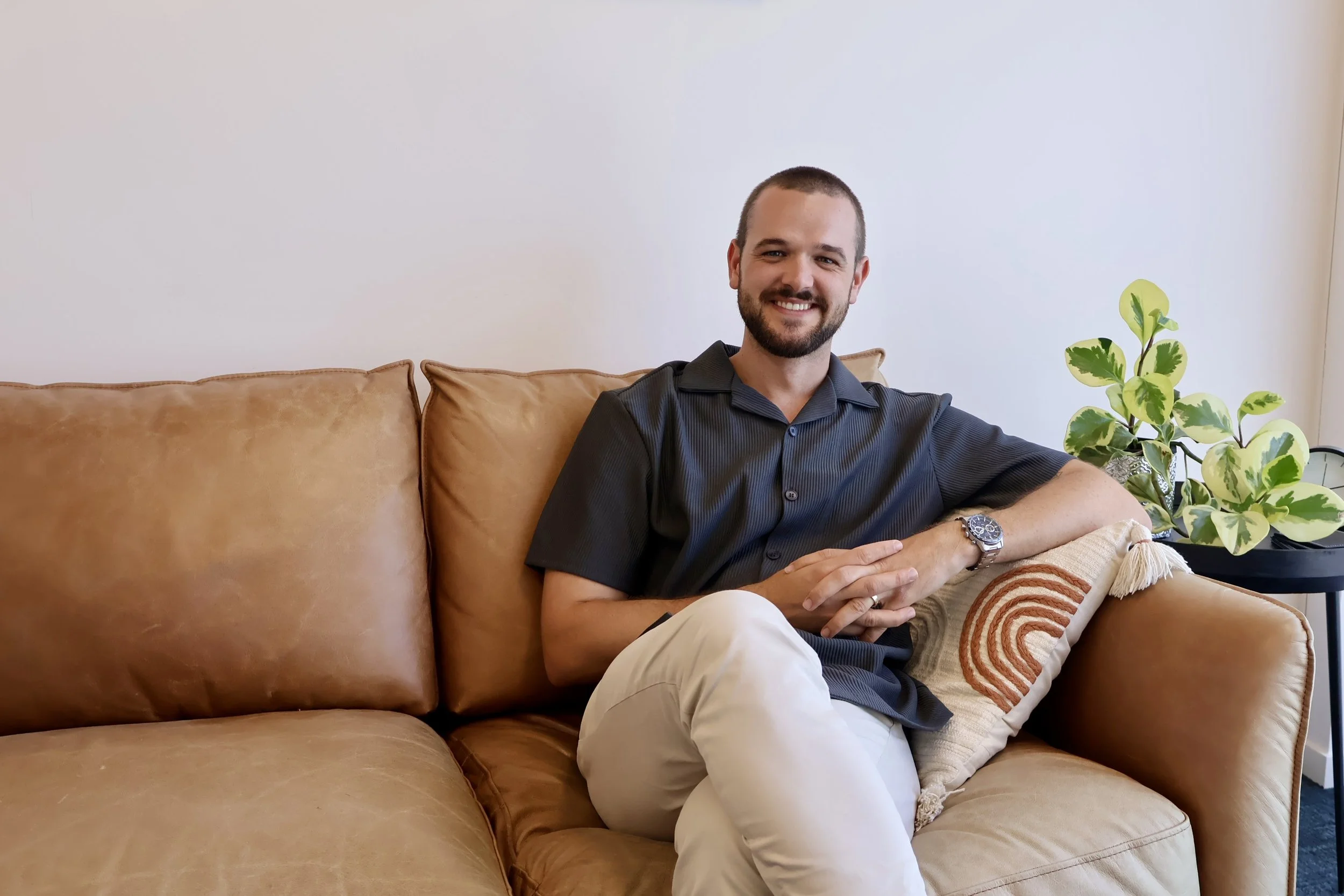 Clinical Psychologist Curtis Cavanagh sitting in clinic in Maroochydore