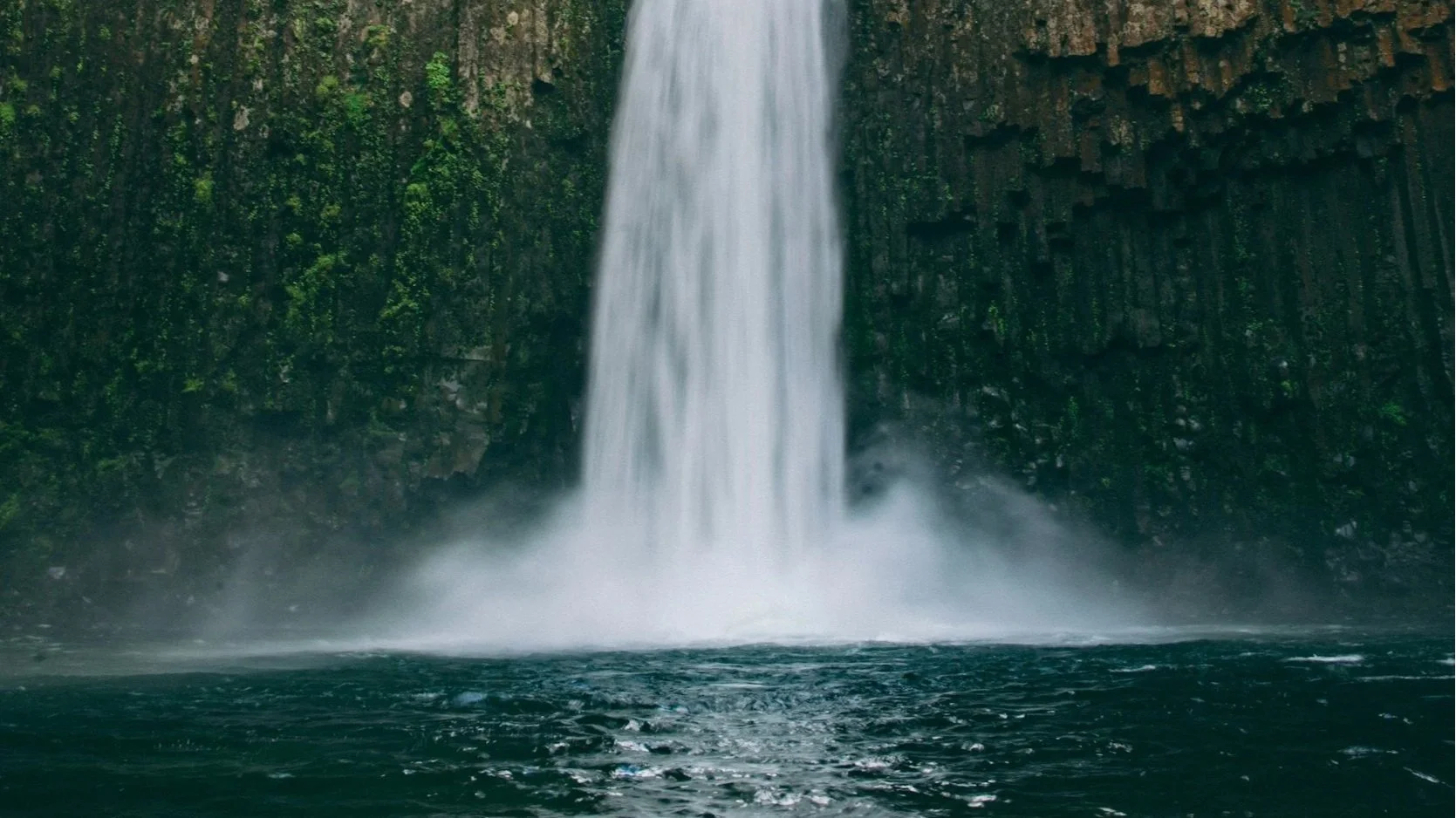 open bible next to mug, overlooking a sparkly water