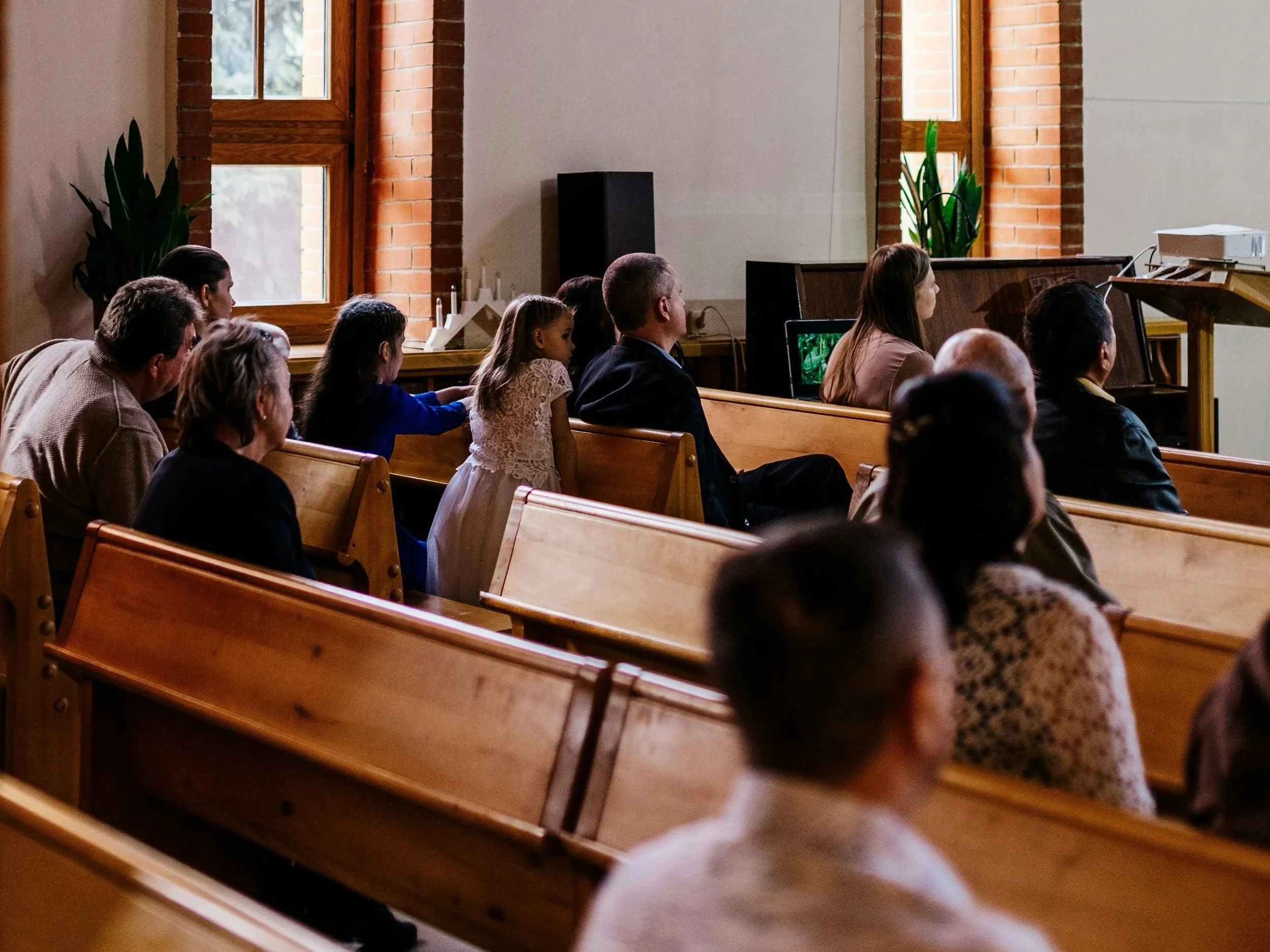 looking diagonally across church pews with a mixed age congregation