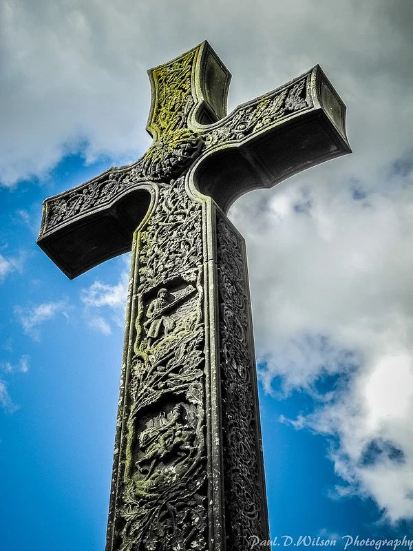 A picture of a Celtic cross against a blue sky