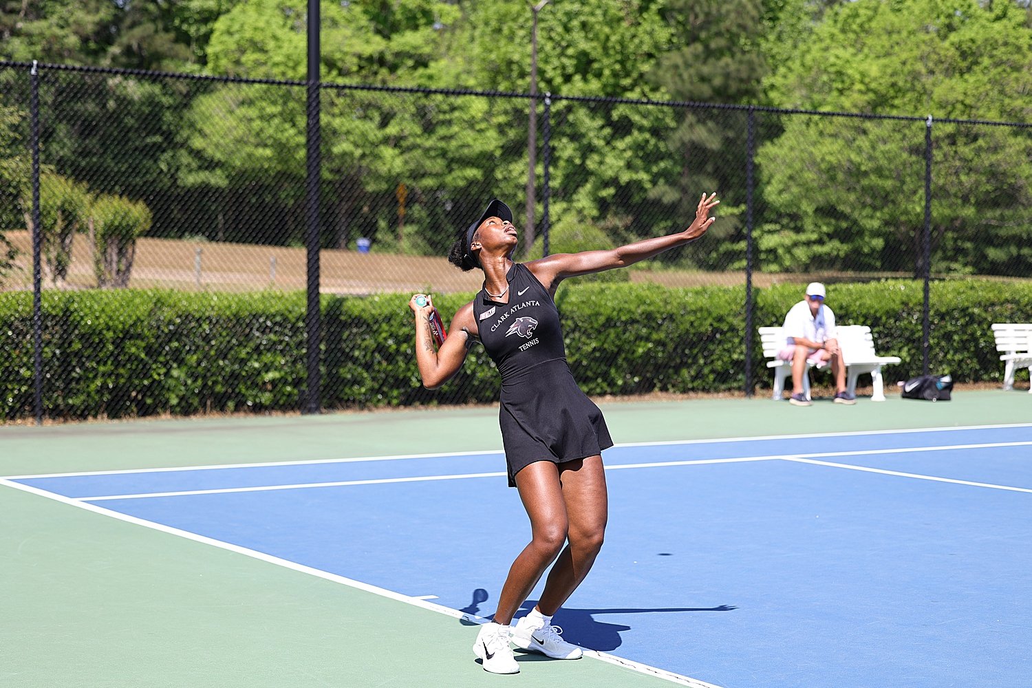woman hitting a tennis racket showing to book your sports photography