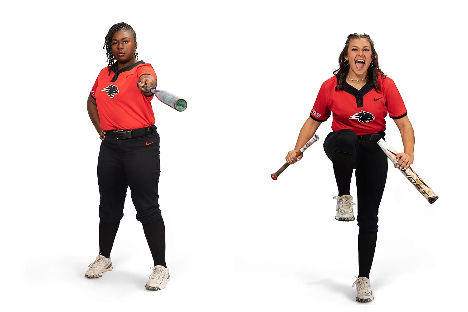  two women in red uniforms stand in studio with bat by Tiaras Monet Photography 