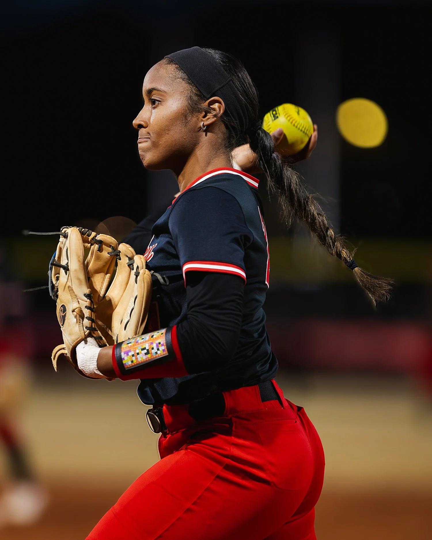  player leans back to throw ball on travel softball teams 