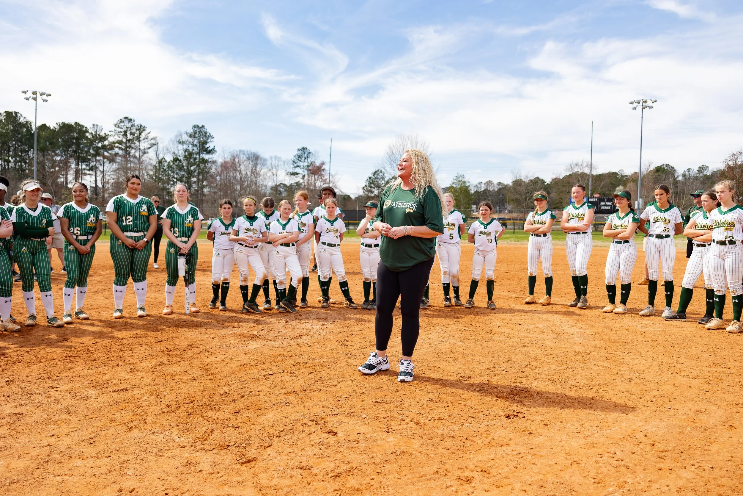  coach stands in front of softball team by Atlanta sports photographer 