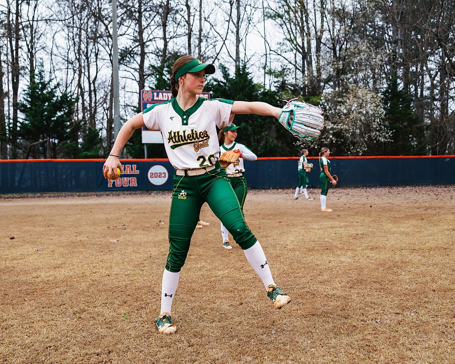  woman throws a ball on field showing when to book a photographer 