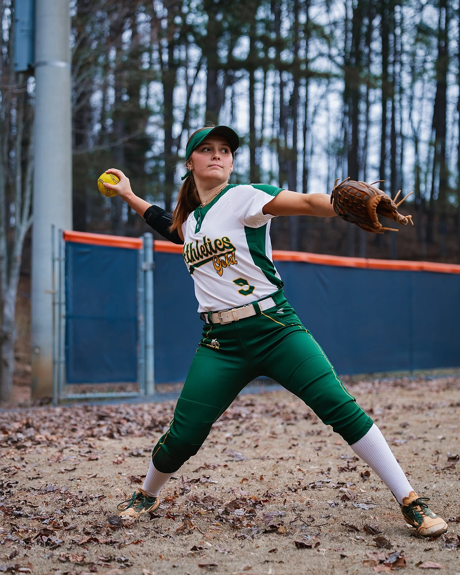 high school athlete throwing softball by Atlanta sports photographer 