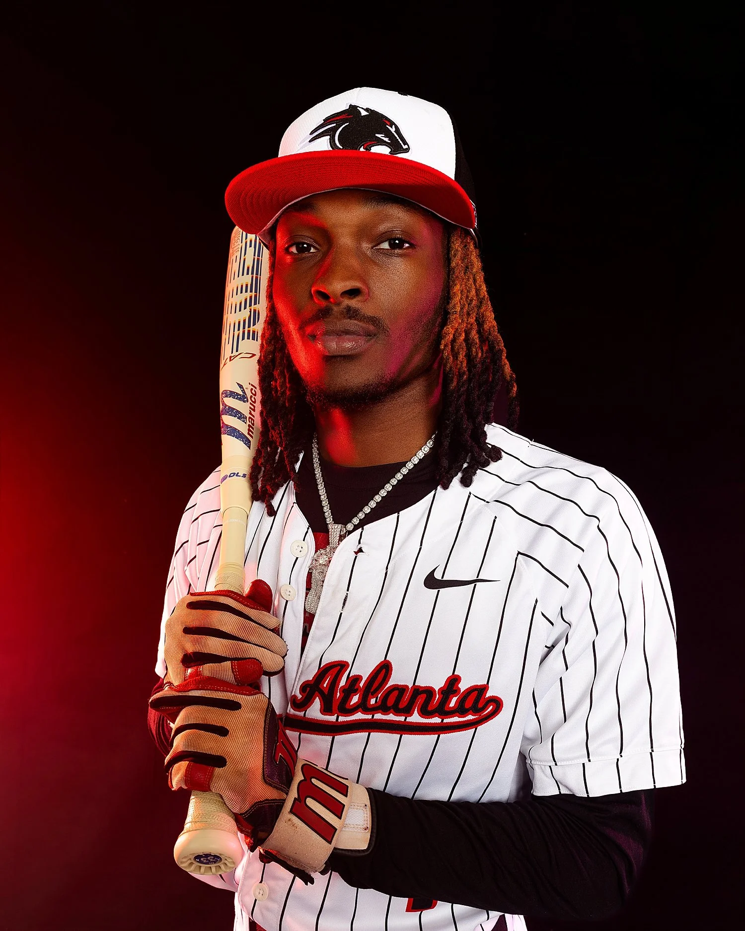  athlete holding a bath stands in red light showing off a media day 