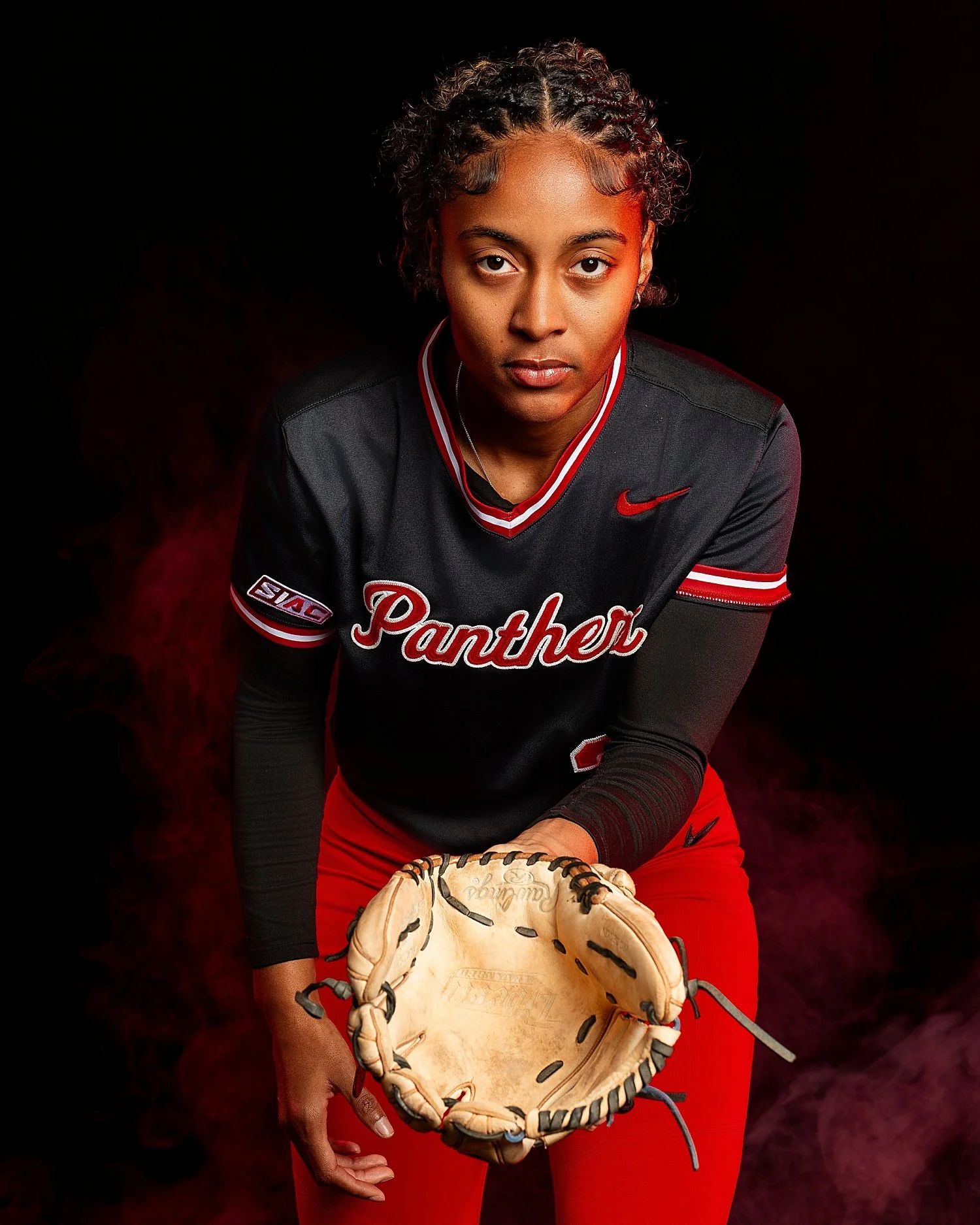  athlete with a glove leans forward in jersey showing off a media day 