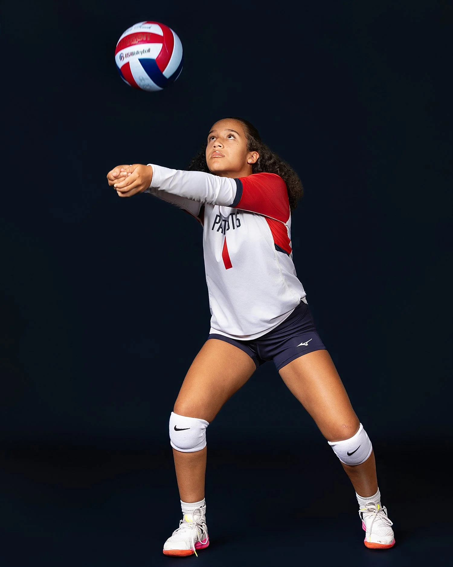  woman playing volleyball against black backdrop by Atlanta Sports Photographer 