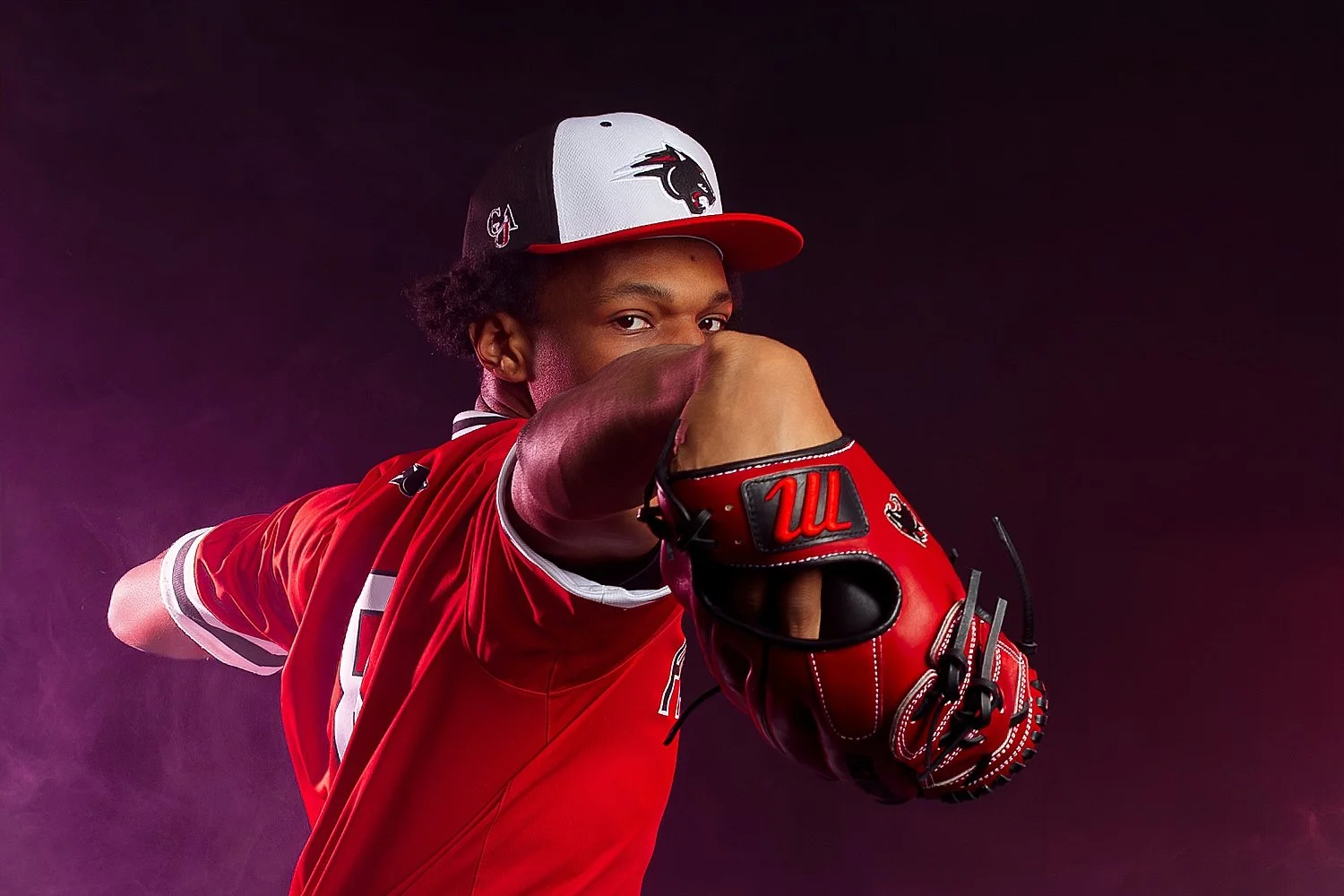  man shows off baseball while in studio by Tiaras Monet Photography 