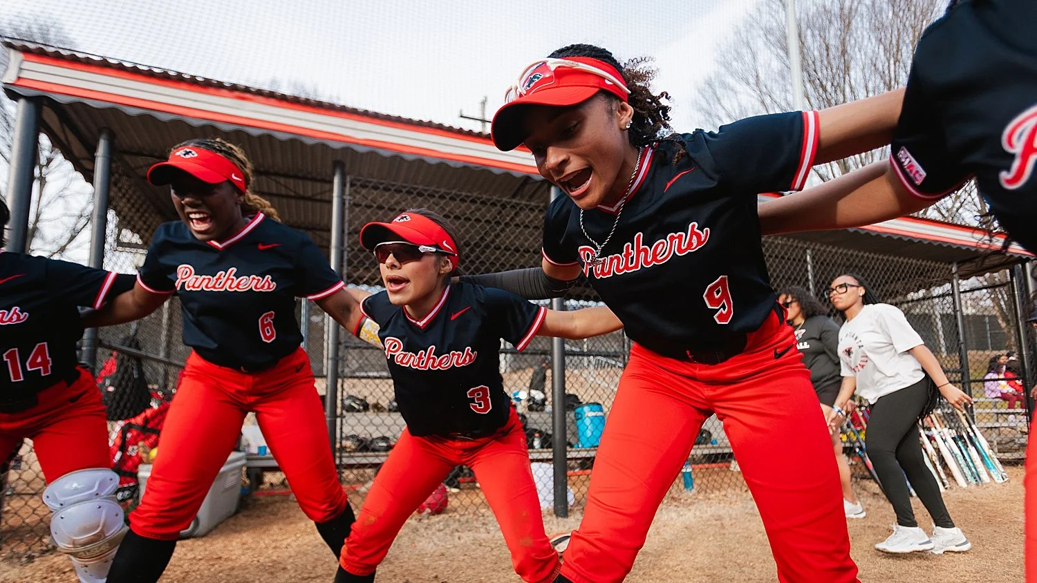 team cheers and gets ready for softball game after building preseason photography checklist
