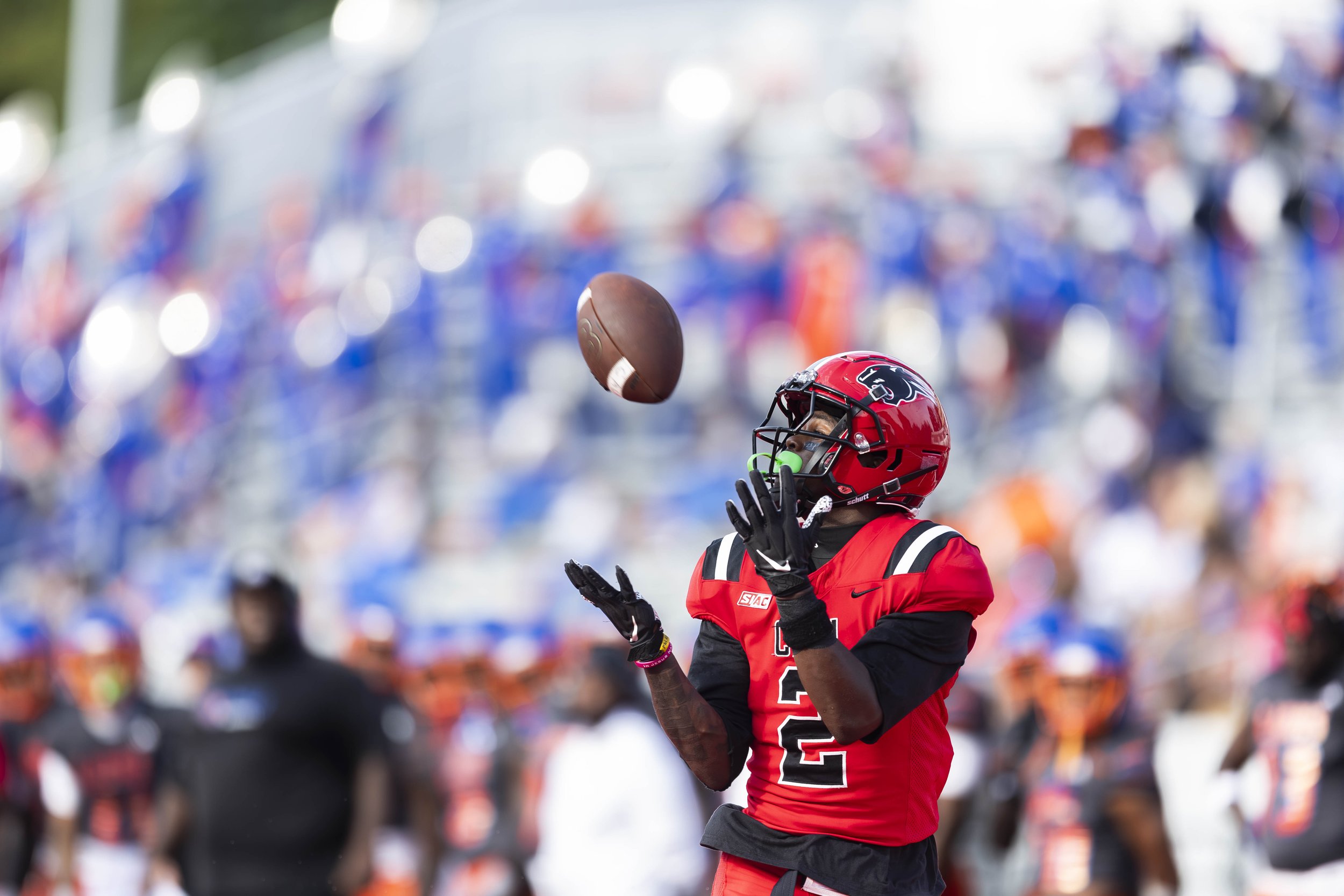 football player catches ball by Tiaras Monet Photography