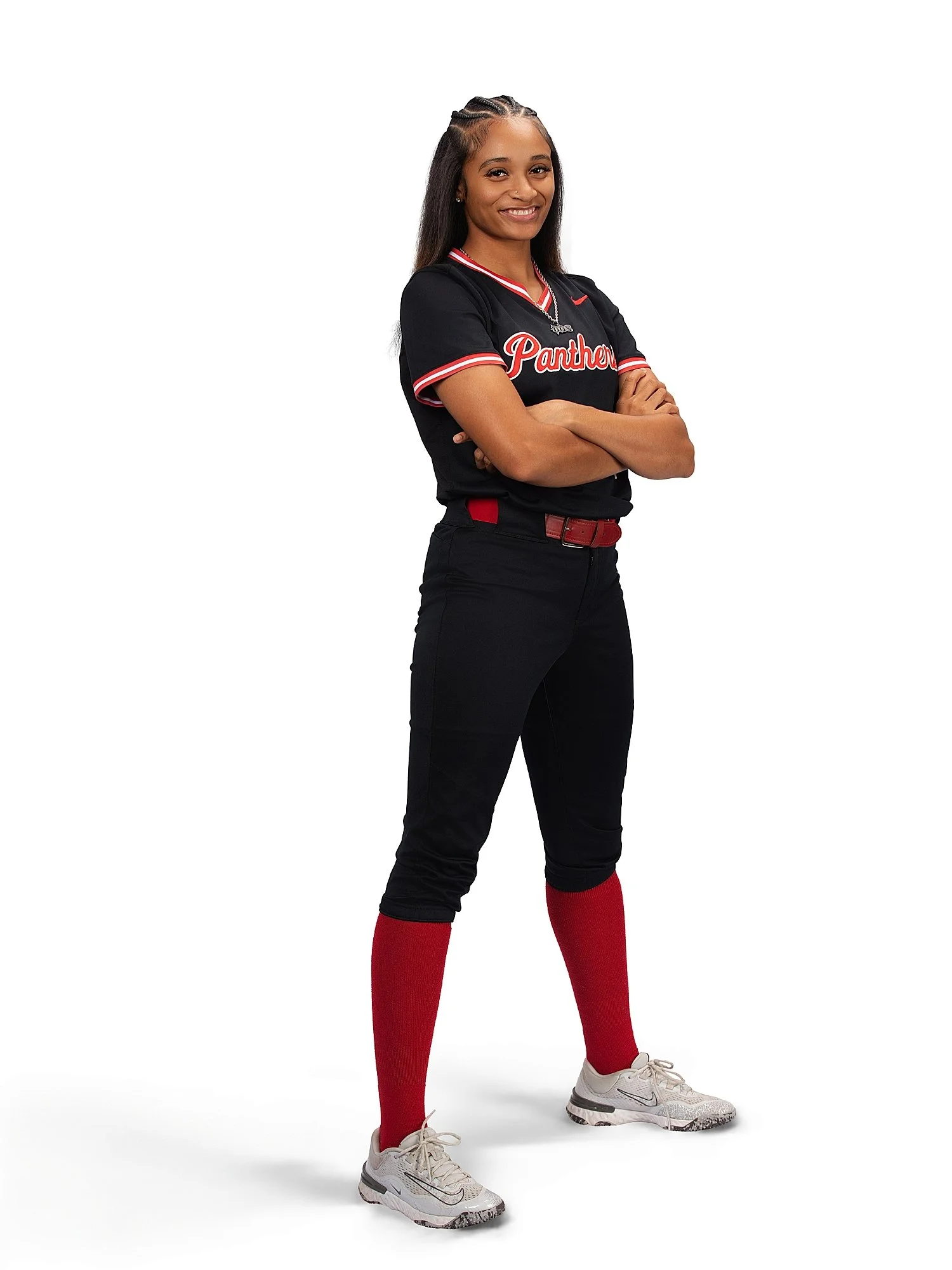 woman stands against white backdrop in sports uniform showing 5 photos every athlete needs