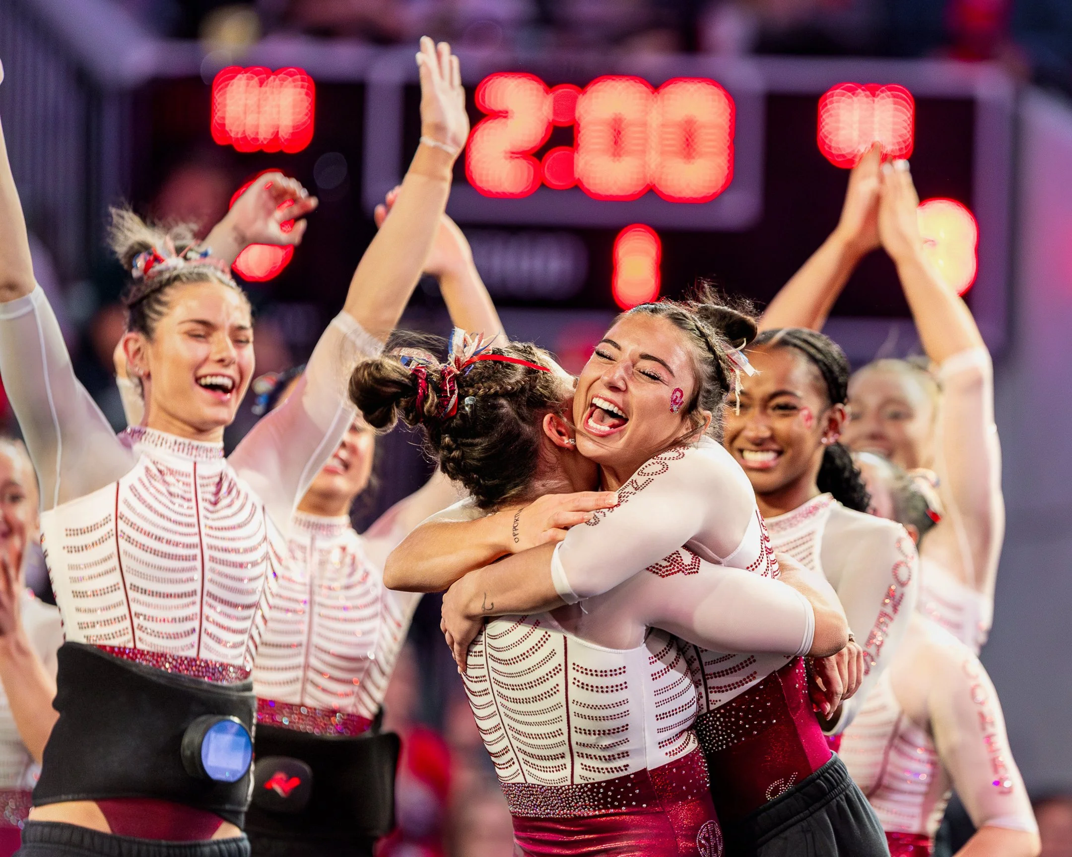 girls high five after gymnastics meet after getting photos within team budget