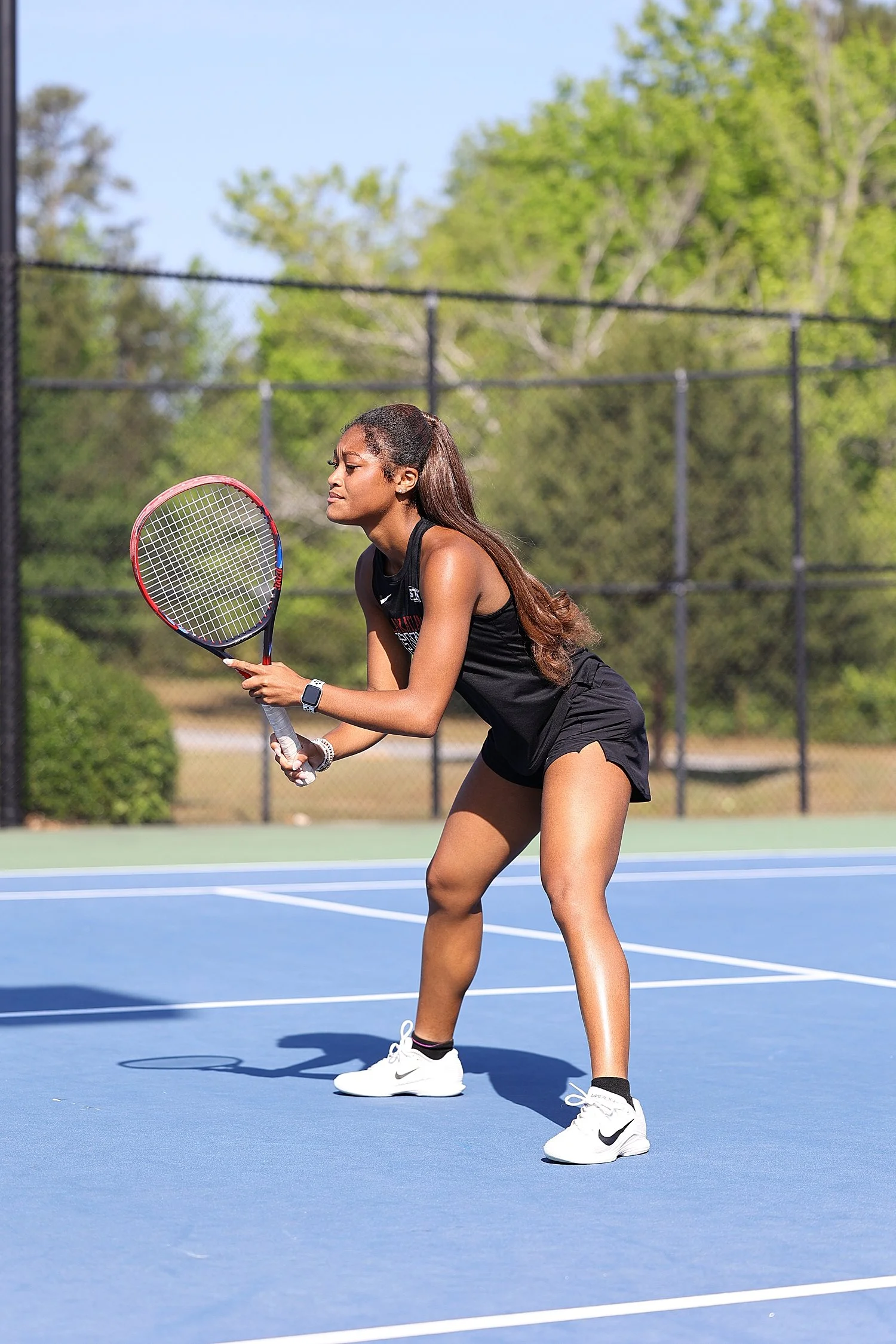 tennis player on court in full sun by Tiaras Monet Photography