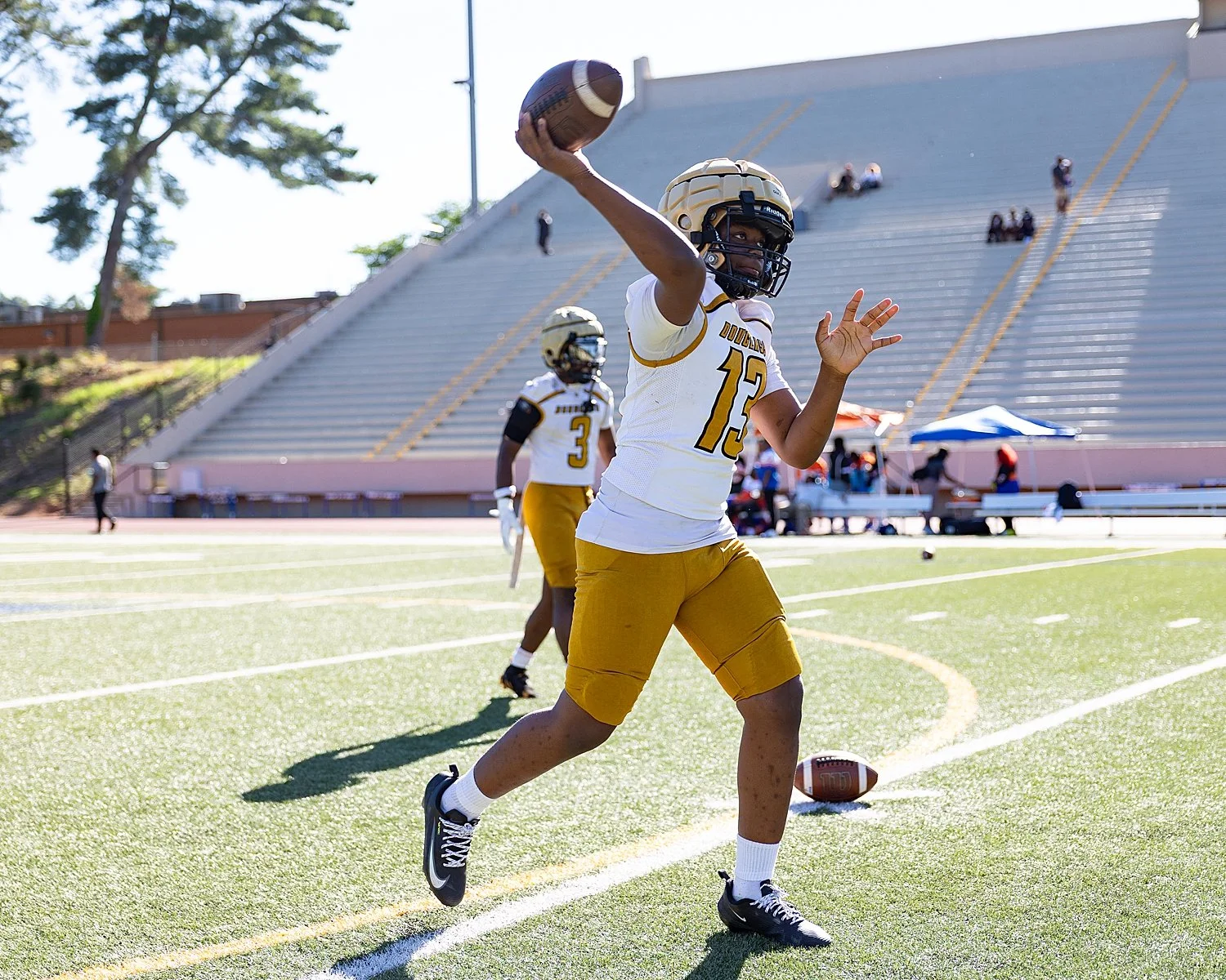 football player tosses ball during practice by Atlanta sports photographer