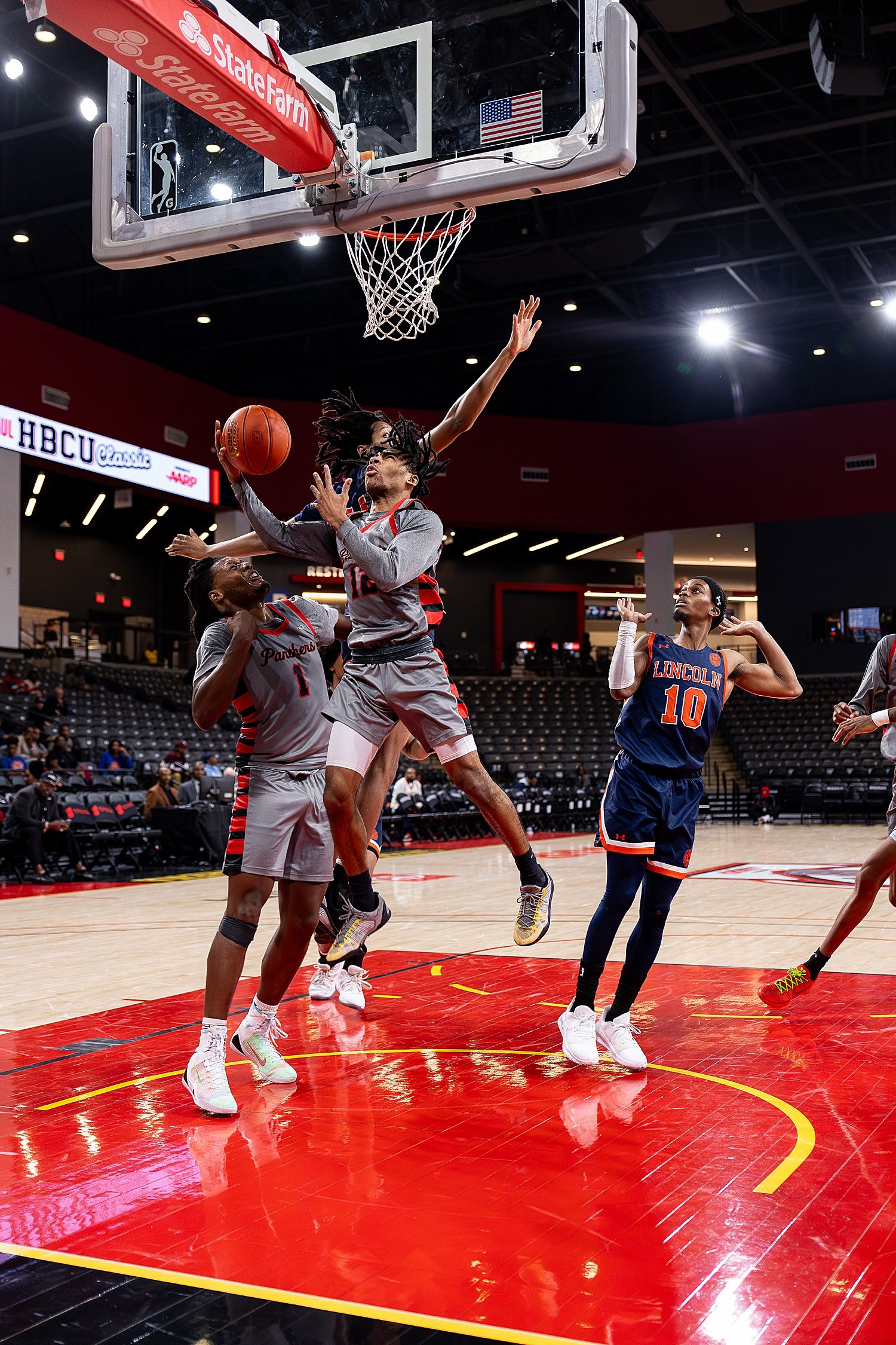 players reach up to shoot basket at game by Atlanta sports photographer