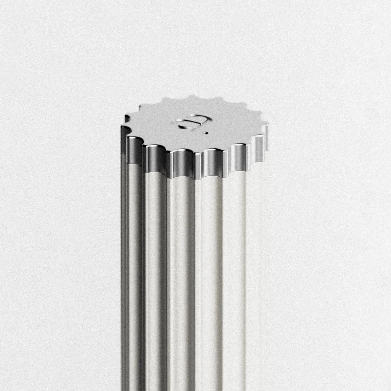 Close-up of a metal gear-shaped object with an embossed Superman logo in the center.