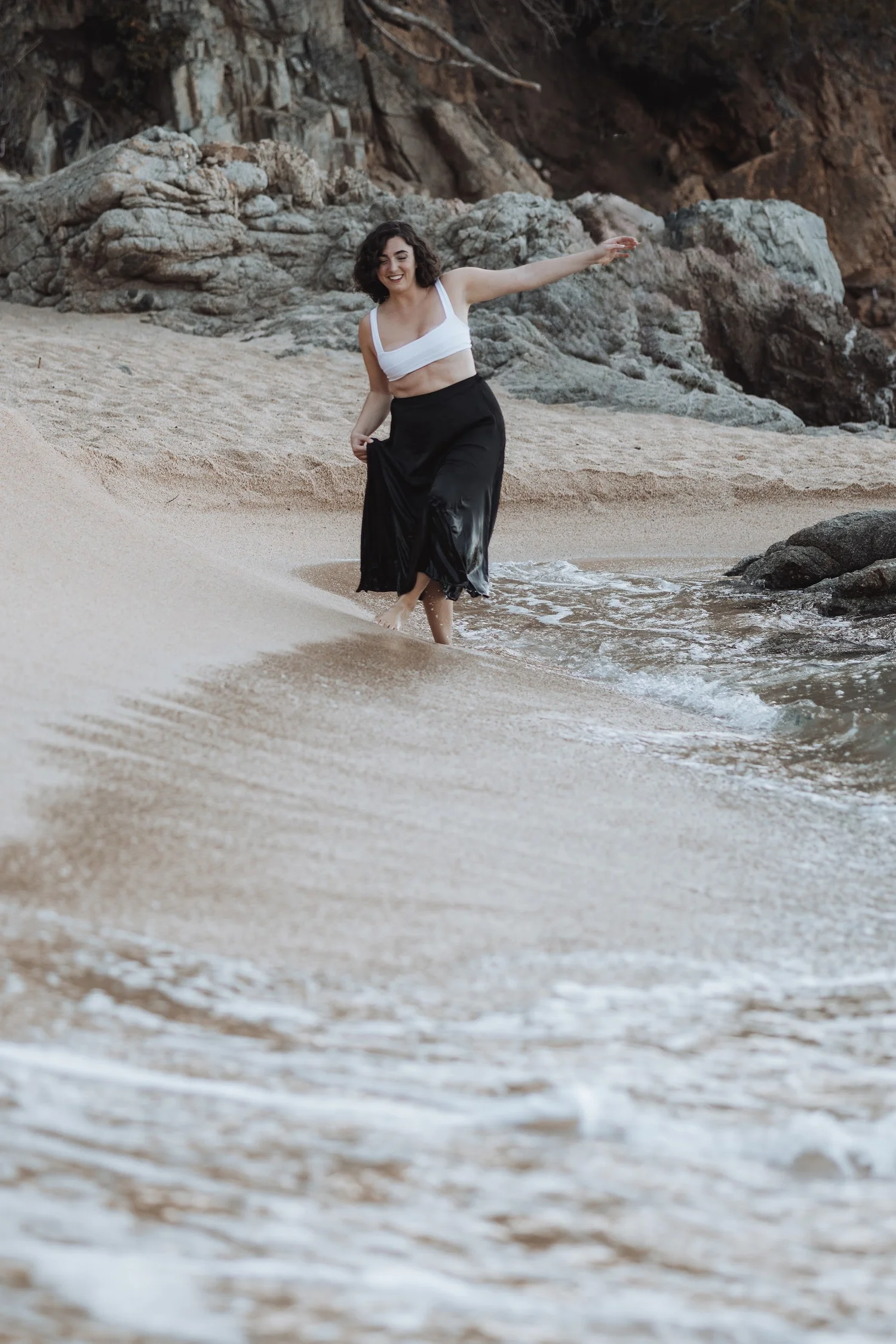 Nicole Siegel dancing at the edge of the sea