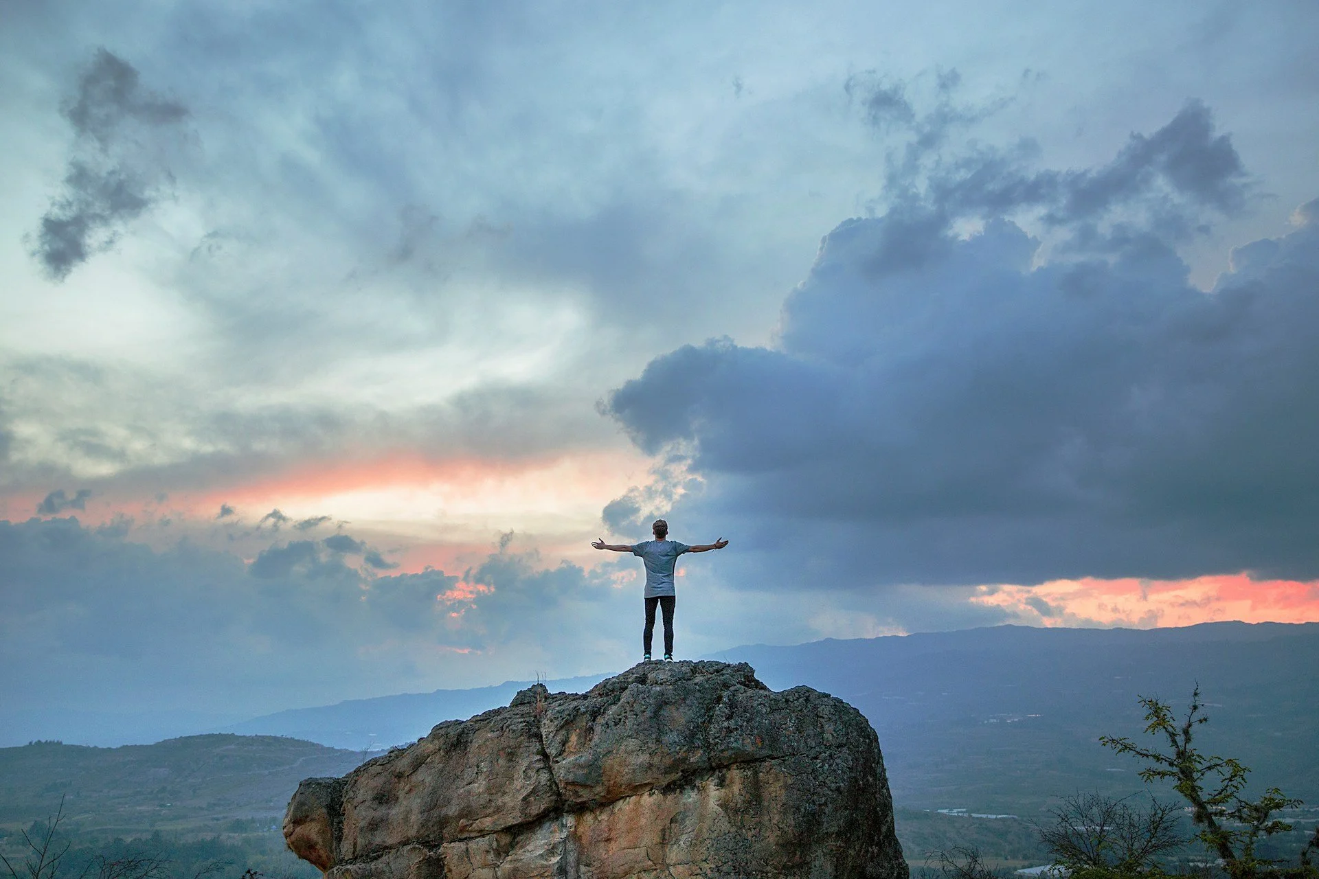 A person standing atop a mountain.