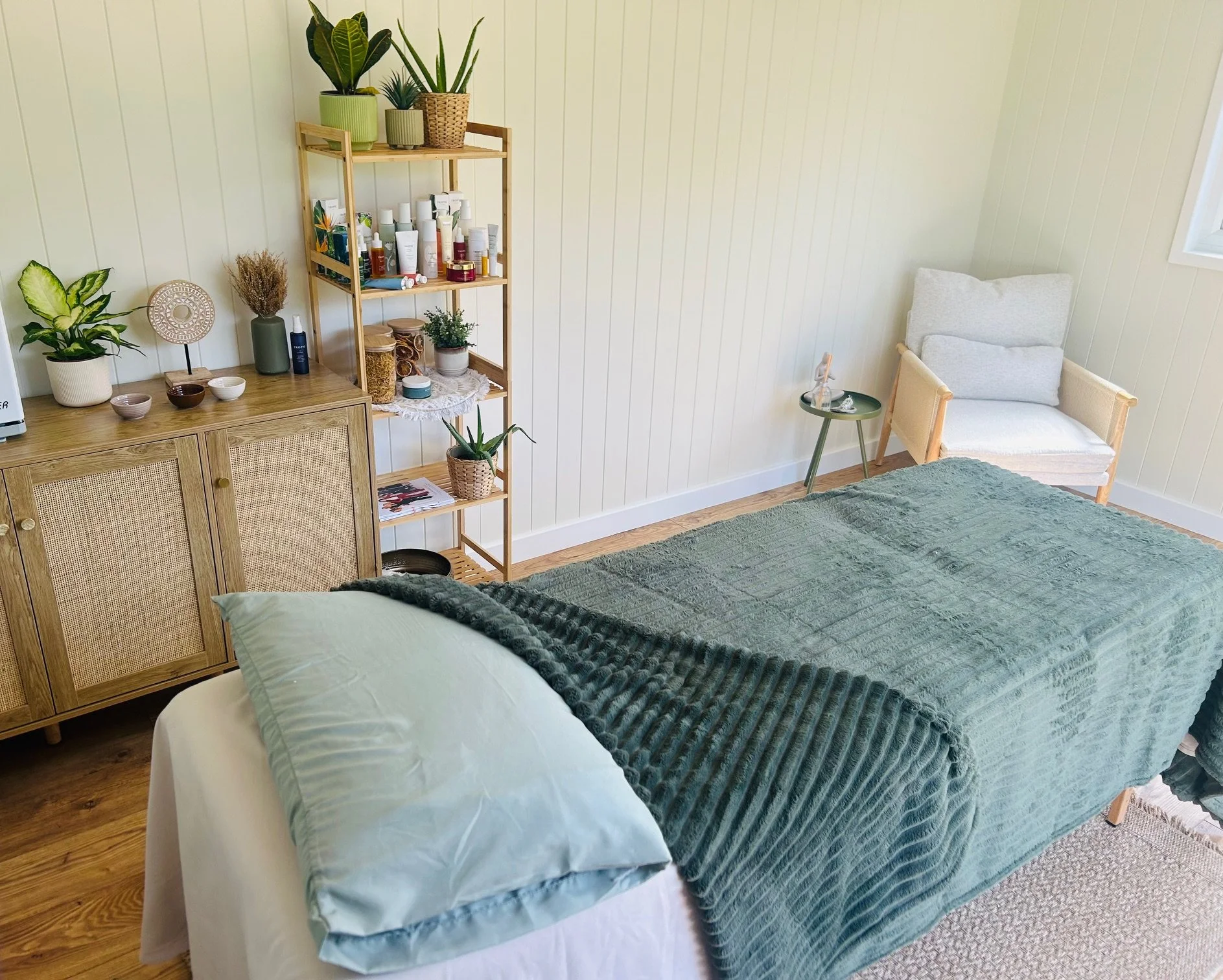 the calm space rituals room with a soft comfy massage bed and tropic skincare display