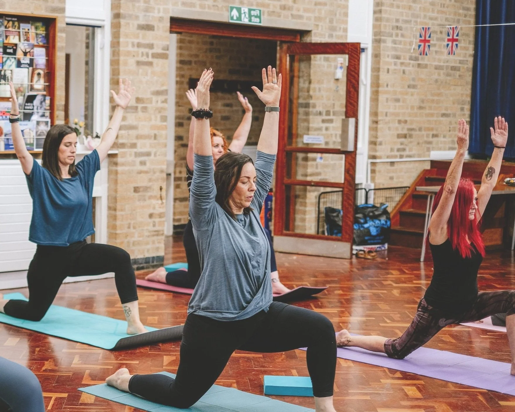 Women practising low lunge in a yoga class