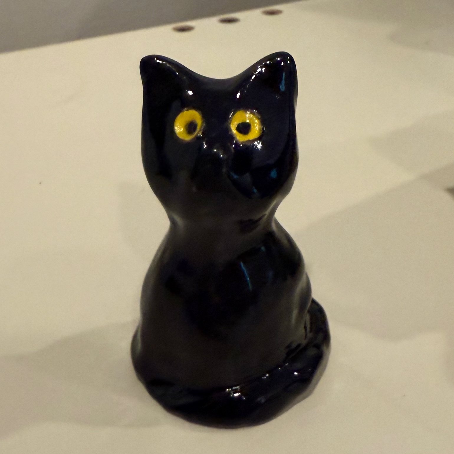 Small Black Cat with Yellow Eyes